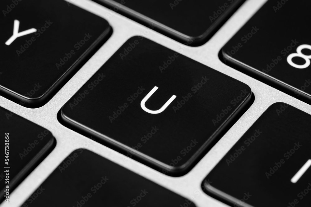 Poster closeup shot of a grey keyboard layout with black keys and white font