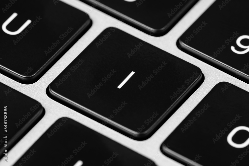 Poster closeup shot of a grey keyboard layout with black keys and white font