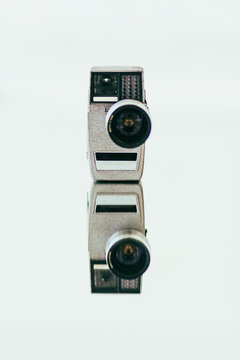 Vintage Super 8 film camera arranged on a mirror with lens flare