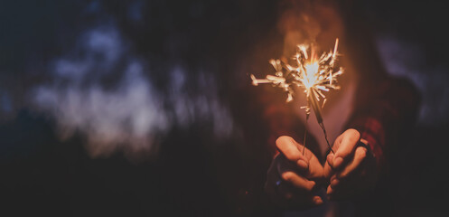 Female hand enjoy with burning Sparkler blast in new year party