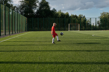 Sporty Kid Kicking Ball