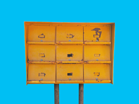 old rusty yellow metal post mailbox isolated.