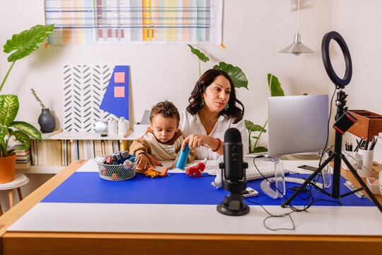 Mother with her little son teleworking