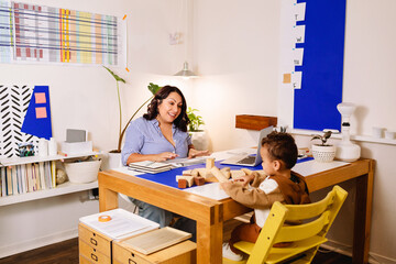 Child speech therapist and little boy at office