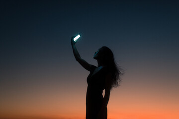 Surreal portrait of woman holding smartphone 