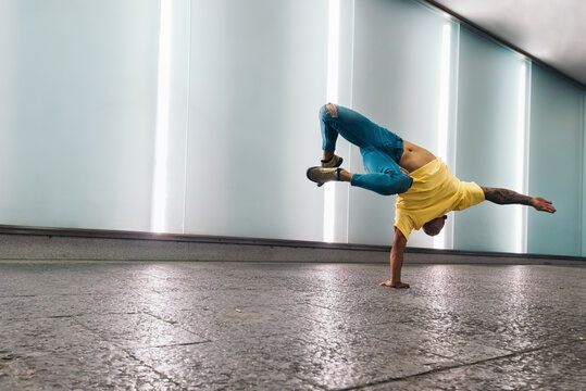 Young man doing a handstand and breakdancing