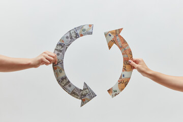 Dollar and euro recycle symbol held by hands.