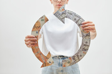 Woman hold recycle symbol of dollars and euros.