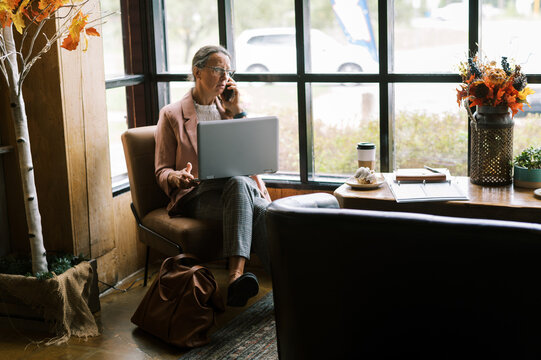 Woman In Business Attire Working At A Cafe