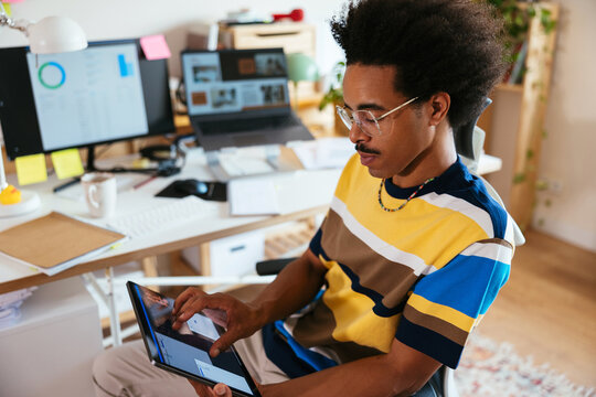 Mixed race freelancer browsing app on tablet