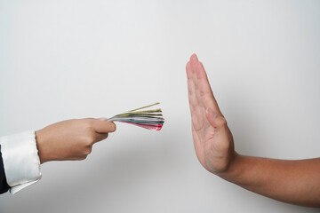 A portrait of businessman refusing money, Indonesian rupiah bills - anti-bribery and corruption...