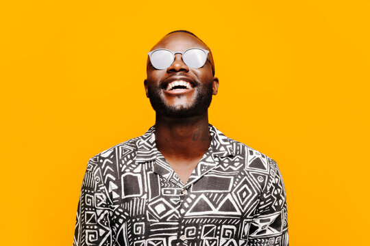 Cheerful black man in trendy outfit
