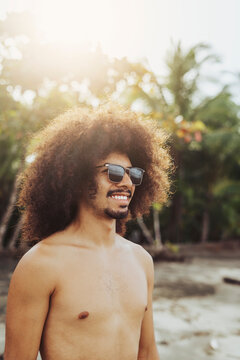 Man with afro hair on the beach. 