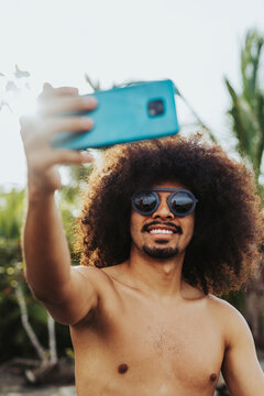 Man with afro hair on the beach. 