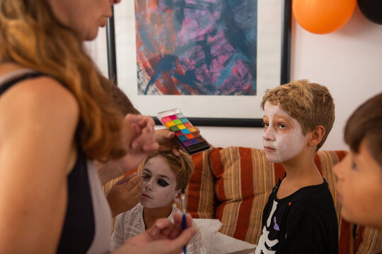 Grup Of Kids Getting Fancy Dress Makeup Put On.