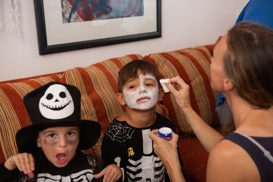 Two little boys dressed as halloween skeletons
