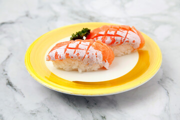Freshly prepared Japanese food called Salmon Belly Nigiri