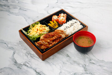 Freshly cooked and prepared Japanese food called Bento meal box © junpinzon
