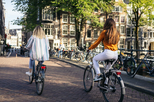 Young People Riding Bikes In Amsterdam