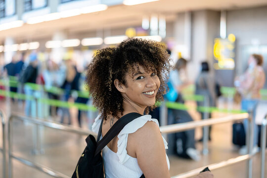 Happy black woman waiting for flight