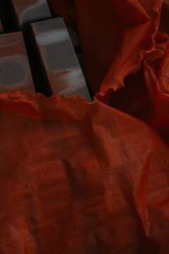 Orange polyethylene film covering the bricks