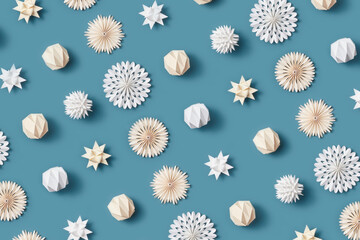Pattern of papercraft baubles on blue background.