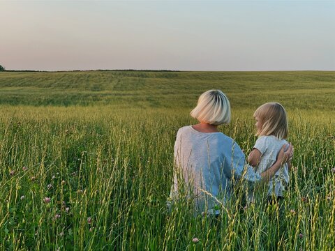 A woman with a child in a wide field.