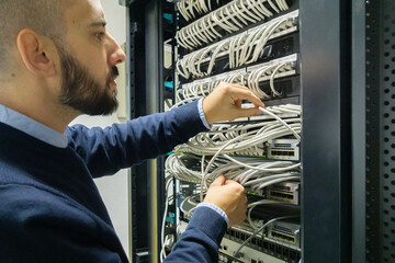 It professional working in a communications rack