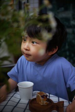 Cute little Asian boy drinking a drink