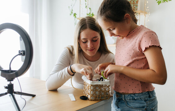 Blogging Woman With Girl And Hair Accessories
