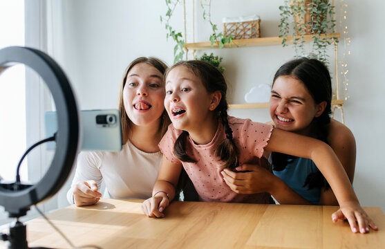 Playful girls recording online video