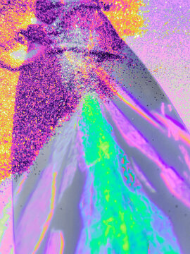 Prism crystal lens sprinkled with bright colorful glitter.