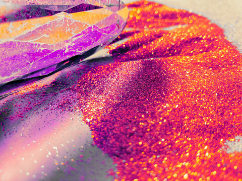 Illuminated vitreous prism in a vibrant golden-purple background.