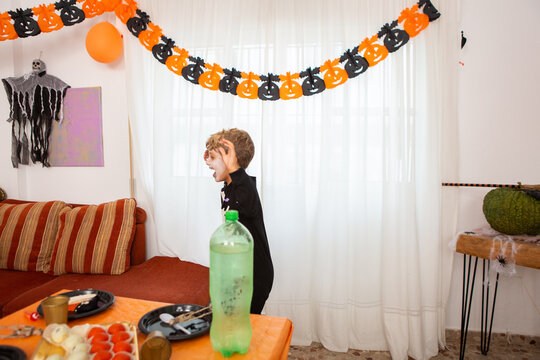 Little Boy Playing A Game At A Halloween Party