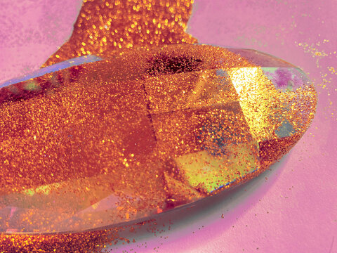 Crystal prism rolled into vibrant golden glitter.