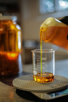 Anonymous Scientist Measuring Liquid in Beaker