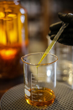 Anonymous Scientist Measuring Liquid in Beaker