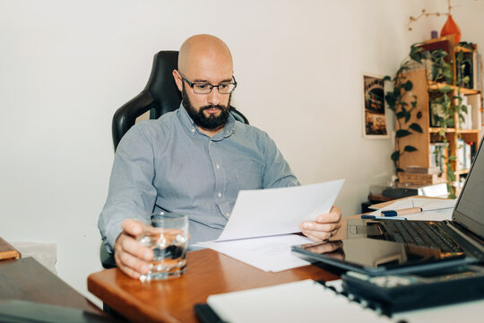 Man reading document at his desk