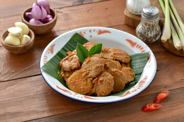 Rendang Jengkol, dogfruit simmered in spices and coconut milk. Indonesian traditional comfort food, with a spicy savory taste typical of rendang and a legit jengkol texture. Served on plate