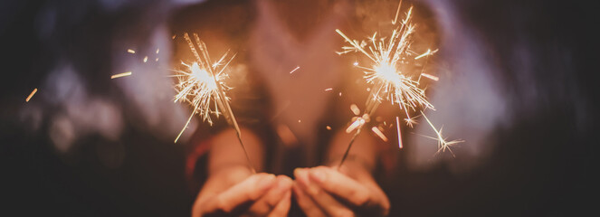 Female hand enjoy with burning Sparkler blast in new year party