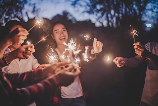 Group of young friend enjoy with burning sparkler in hands together