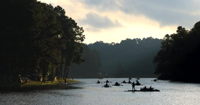 Silhouette tourists are rafting in morning sunlight at Pang Ung mea hong son province, Thailand, 4k video
