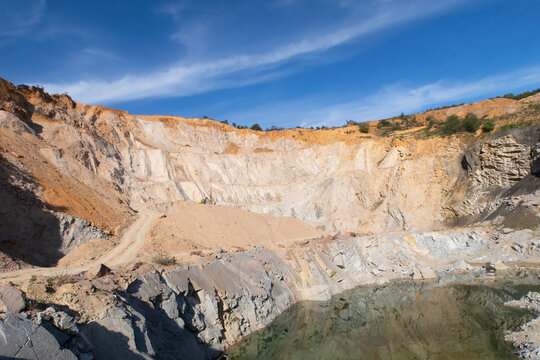 mine rocks, artificial lake and blue sky