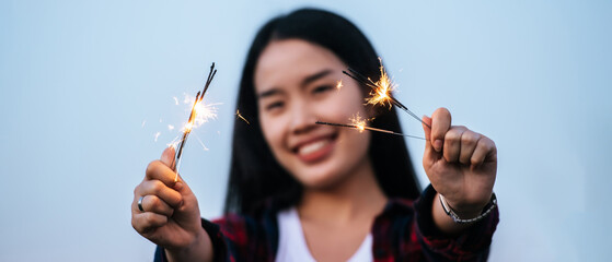 Asian pretty girl holding burning sparkler celebration in New year