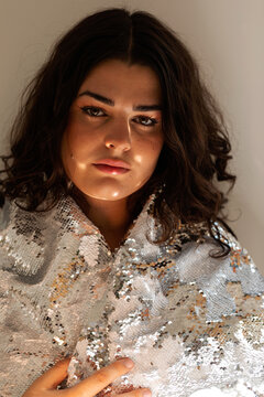 Trans woman with sequin silver cape portrait