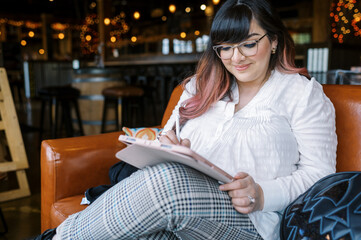 Female artist drawing on a tablet at a cafe
