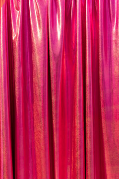 Pink curtain with subtle glitter and yellow shine. Empty space. 