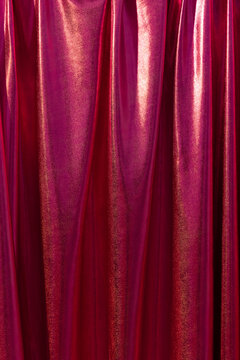 Red curtain with subtle glitter and yellow shine. Empty space for text
