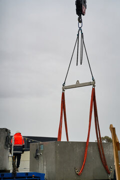 Crane straps being attached to spa pool on truck