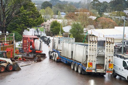 Truck delivering in-ground spa pools to construction site